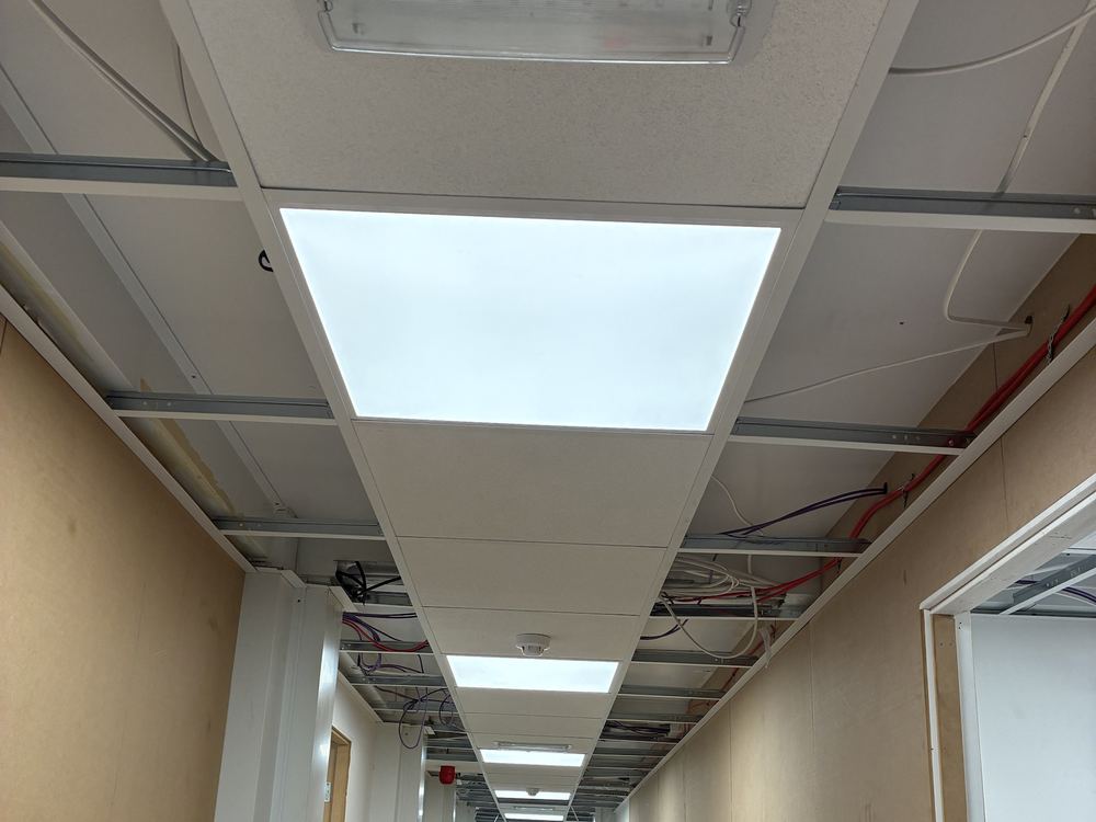 Corridor with LED panels and emergency lighting