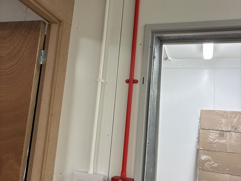 Fire alarm call point and red fire-rated cabling