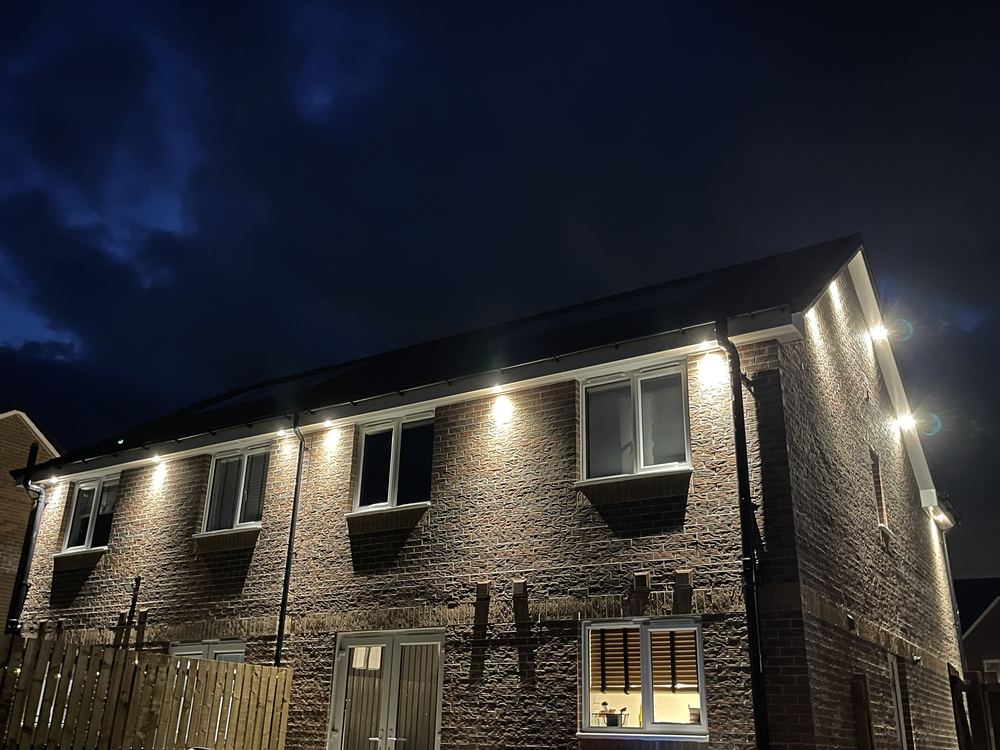 Soffit downlights lighting up a new-build home at night