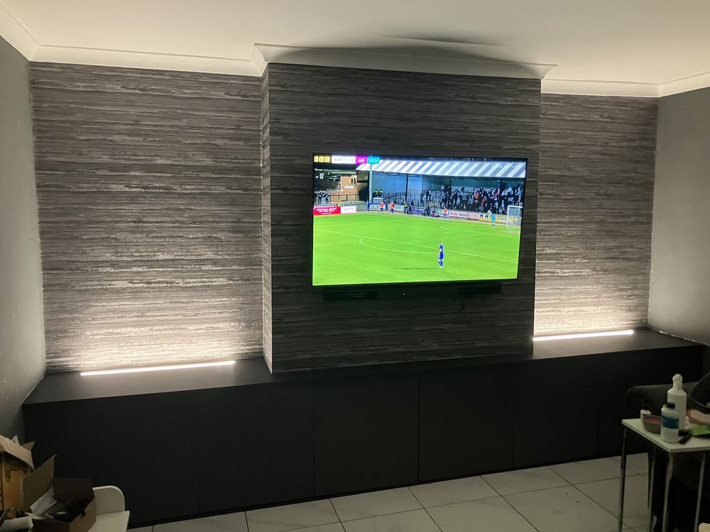 Feature wall with LED strip lighting around a wall-mounted TV